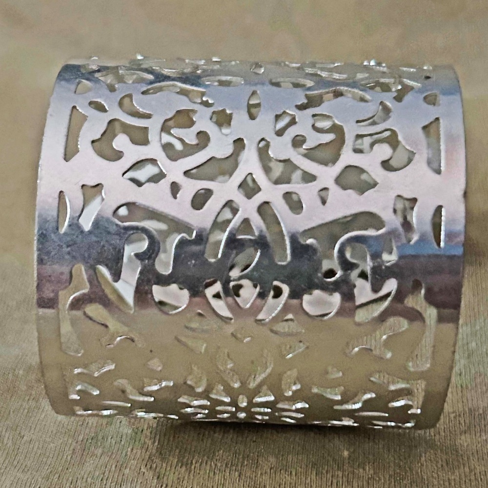 BRACELET, SILVER TONE METAL WITH CUT OUT DESIGNS,  6 ⅜ x 2 ½ INCHES, TAG ON,